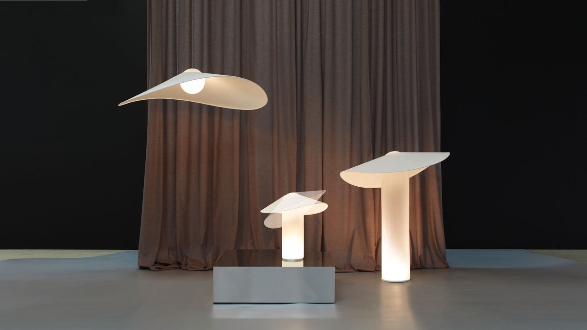 LOJA lighting family by Sebastian Herkner for Midgard, with pendant, table and floor lamps featuring sculptural paper shades and hand-blown glass bodies.