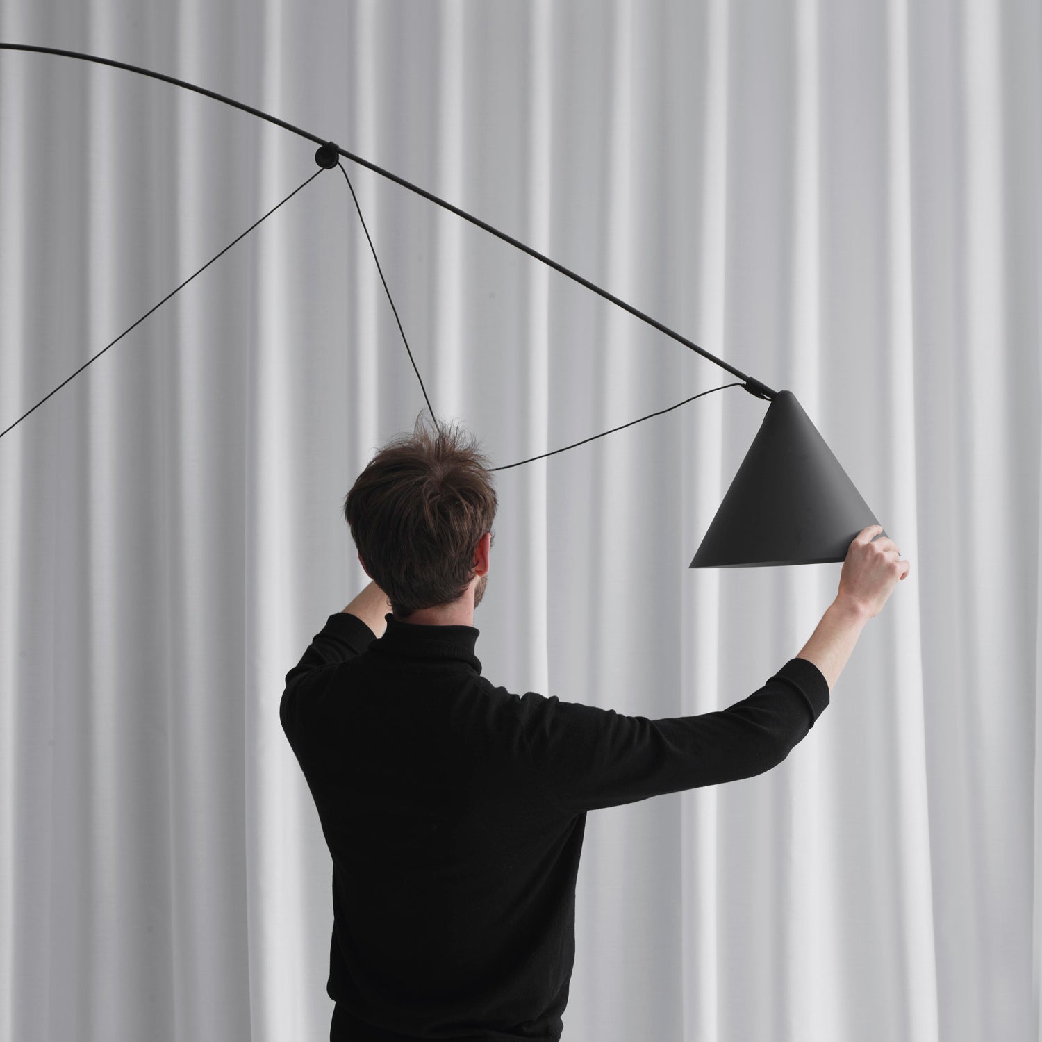 Detail of the pivoting shade and joint mechanism of the Ayno XL floor lamp in matte black