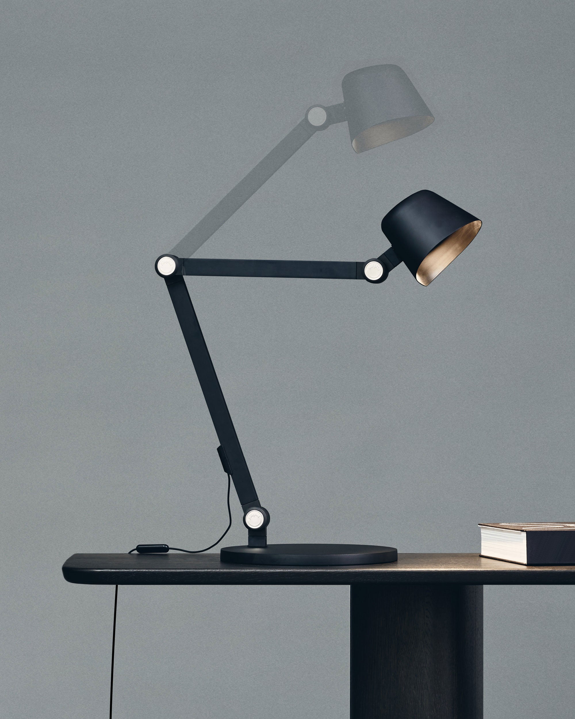 Midgard Modular NEO table lamp showing its articulated construction and extensive adjustability
