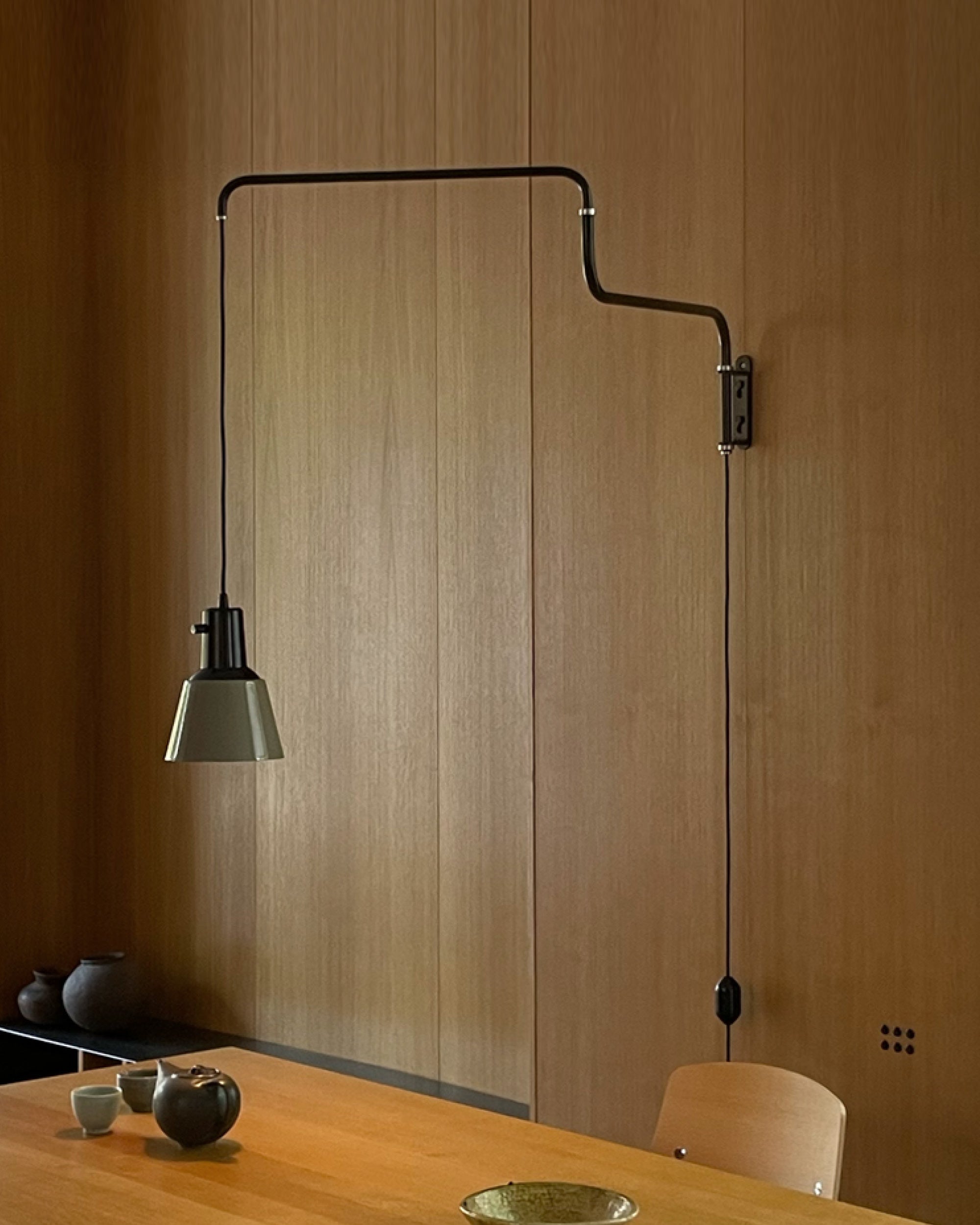 K830 wall by Midgard with freely rotating tubular steel arms for highly adjustable directional lighting