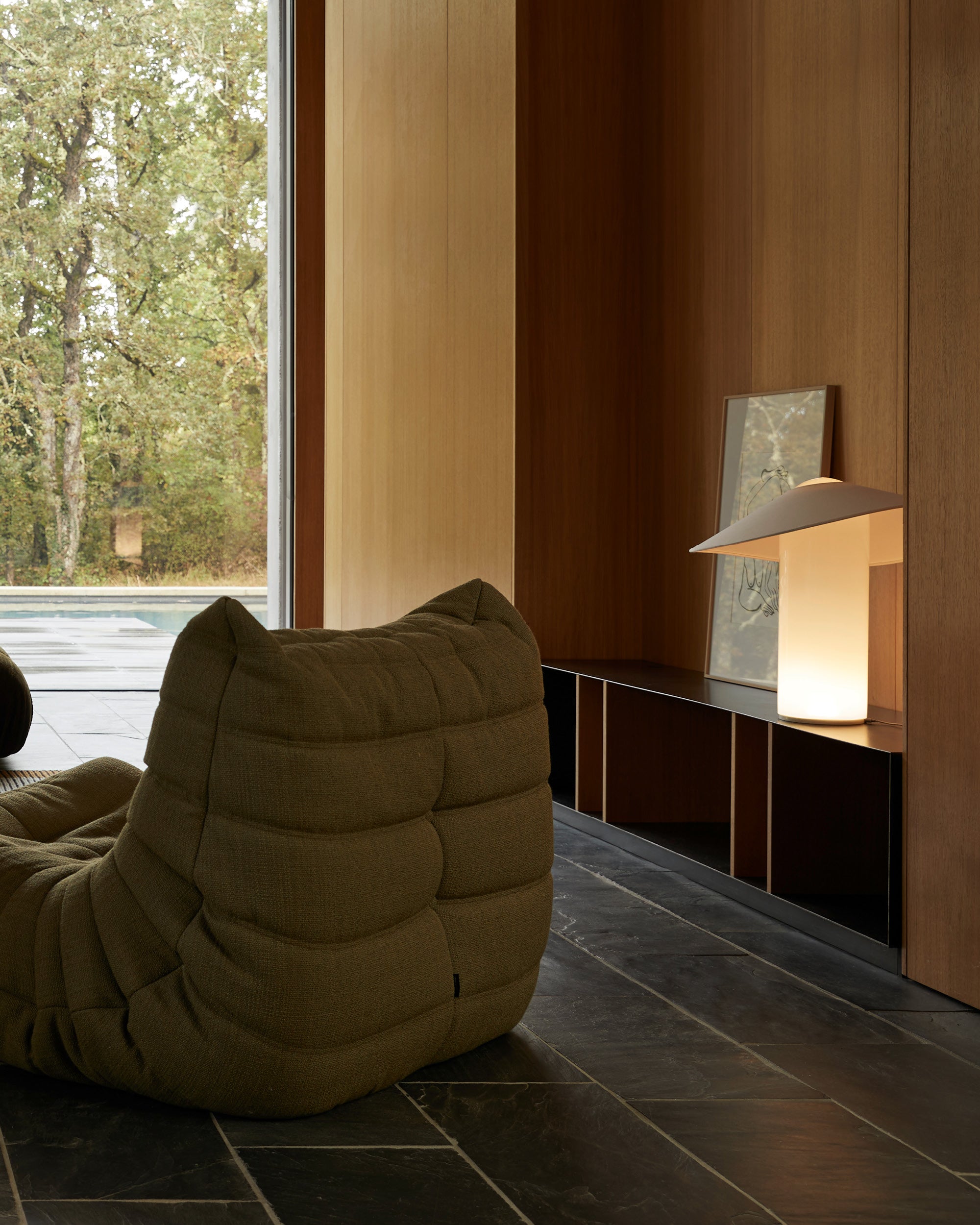 LOJA table lamp designed by Sebastian Herkner for Midgard, providing direct and indirect Tunable White LED light in a living interior.