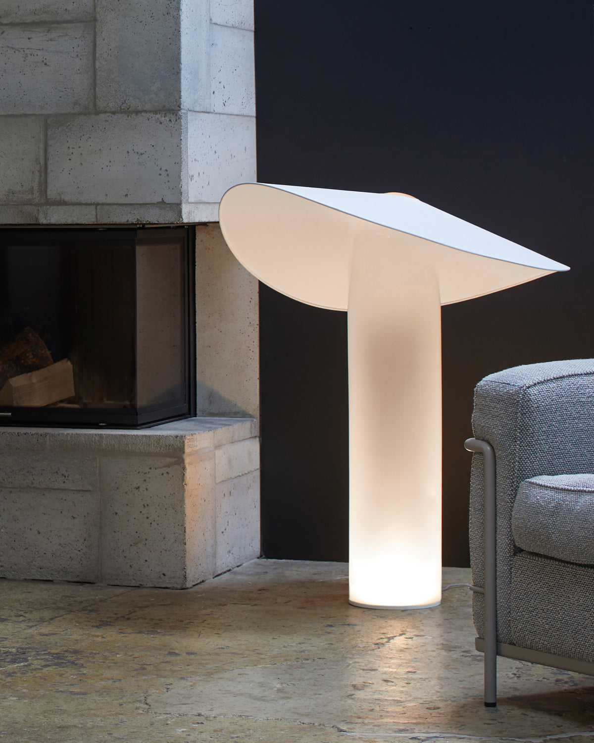 LOJA table lamp designed by Sebastian Herkner for Midgard, featuring a curved paper shade balanced on hand-blown glass.