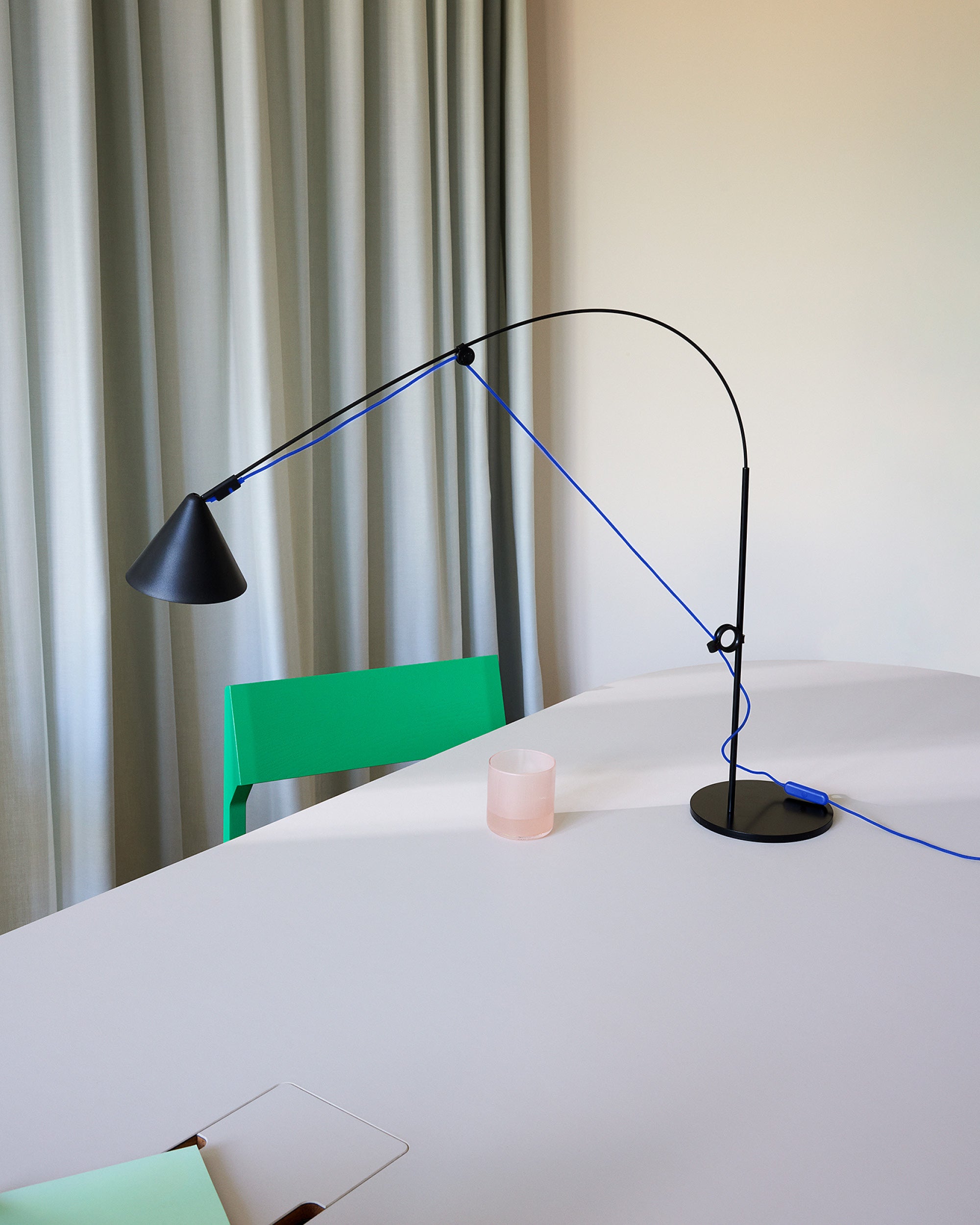 Midgard AYNO S adjustable table lamp in black with ultramarine blue textile cable in a modern interior