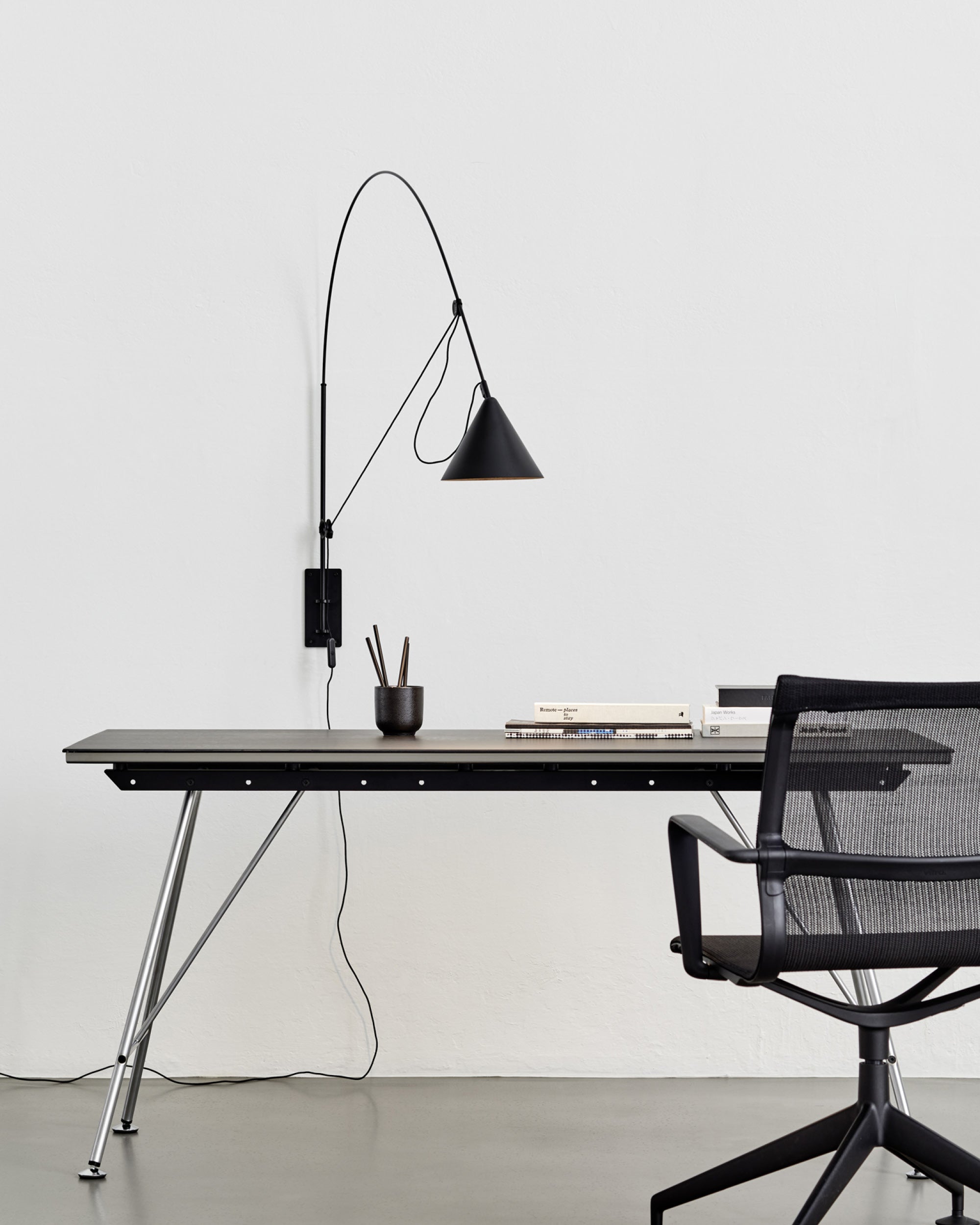 Midgard AYNO L adjustable wall lamp in black in a modern workspace interior