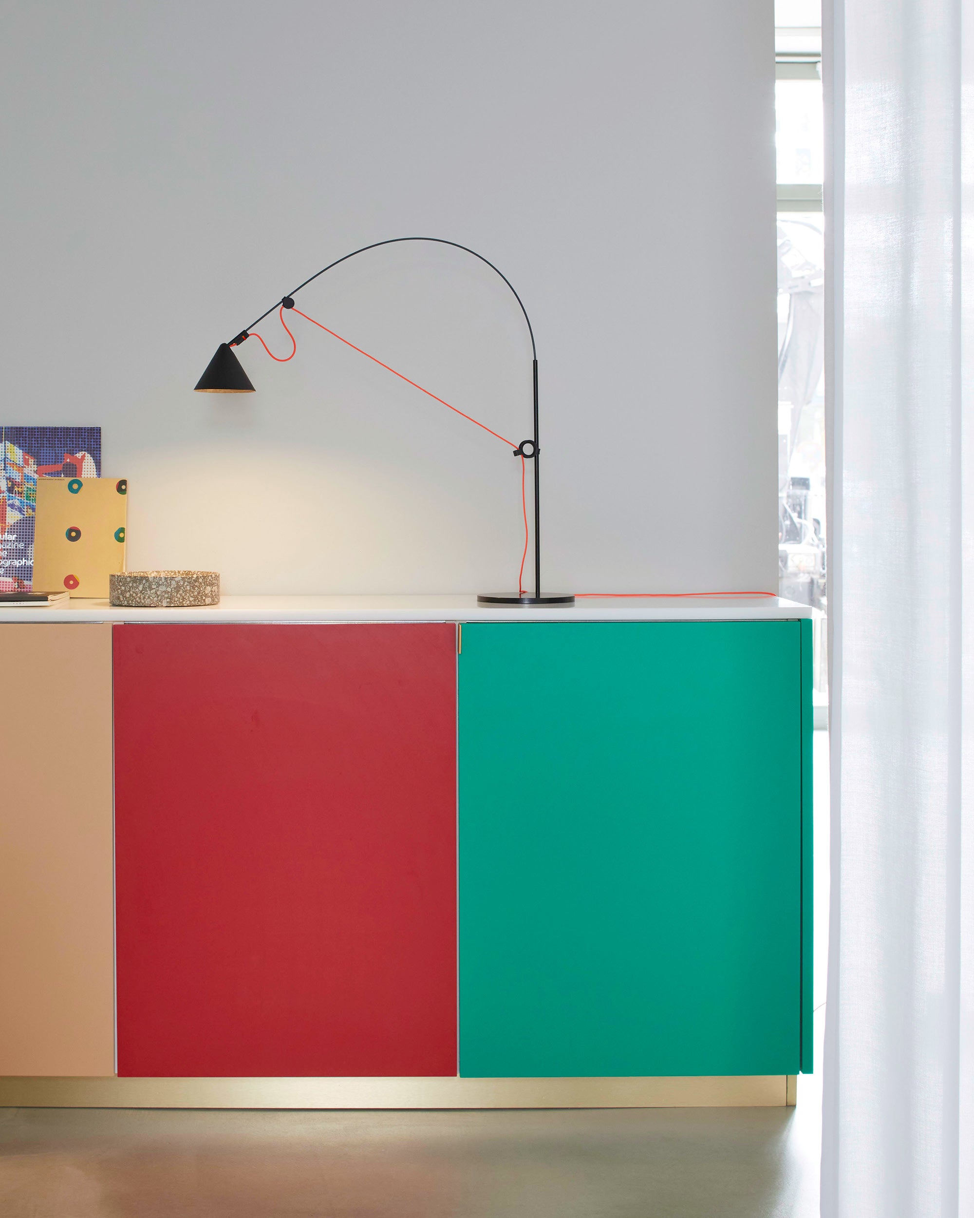 Midgard AYNO S adjustable table lamp in black with neon orange textile cable in a modern interior
