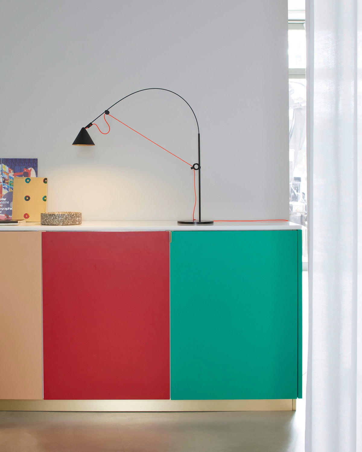 Midgard AYNO S adjustable table lamp in black with neon orange textile cable in a modern interior