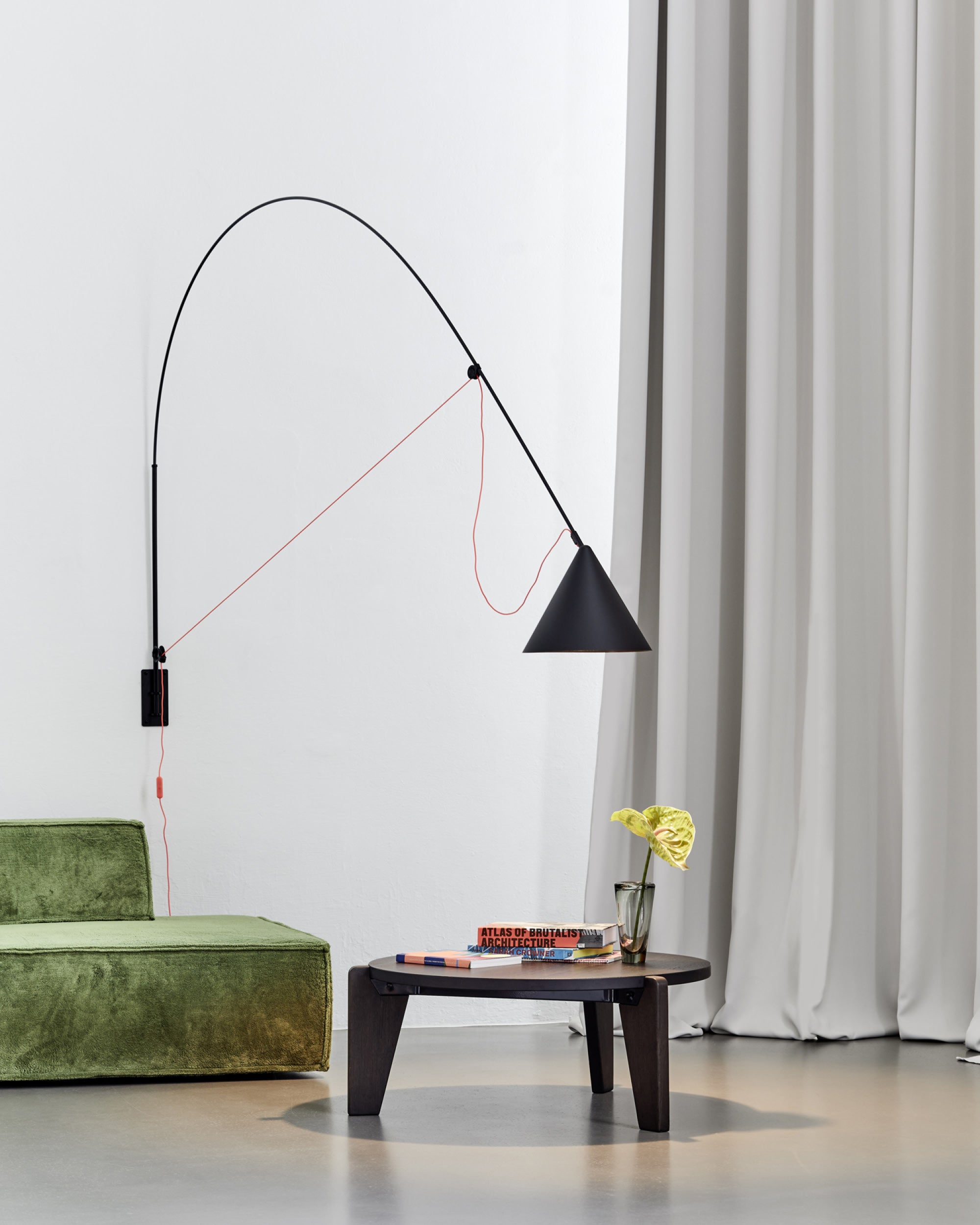 Midgard AYNO XL adjustable wall lamp in black in a modern lounge interior