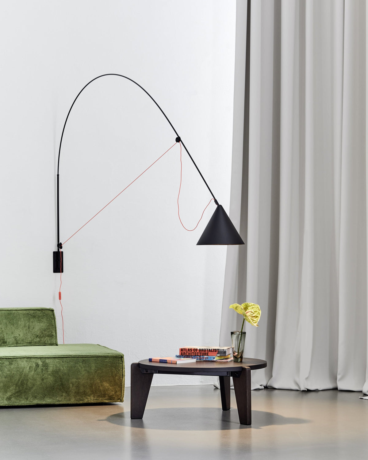 Midgard AYNO XL adjustable wall lamp in black in a modern lounge interior