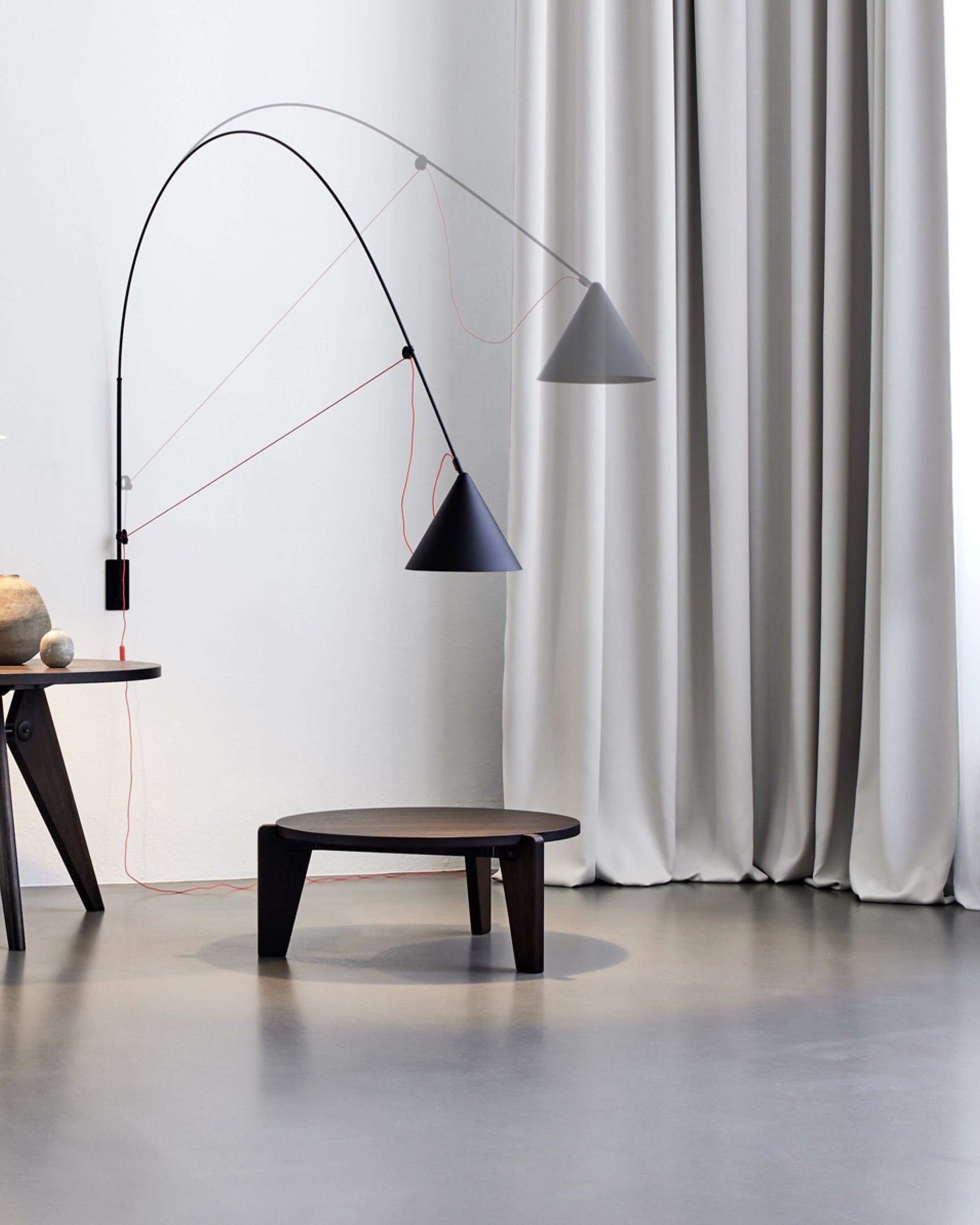 Midgard AYNO XL adjustable wall lamp in black demonstrating its patented adjustment principle and exceptional reach