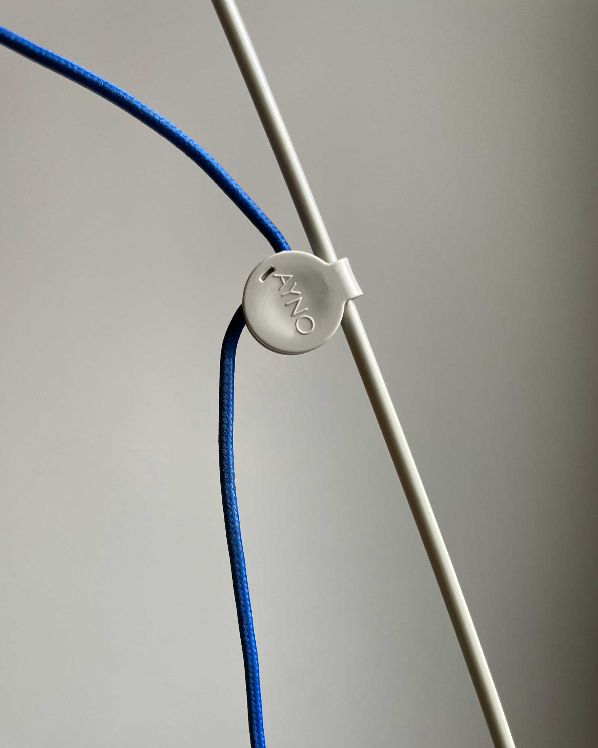 Patented adjustment ring and ultramarine blue textile cable of the Midgard AYNO L floor lamp in silk grey