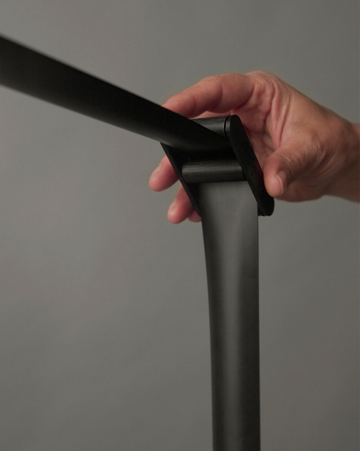 Hand adjusting the precision slider of the RAY by Midgard lamp